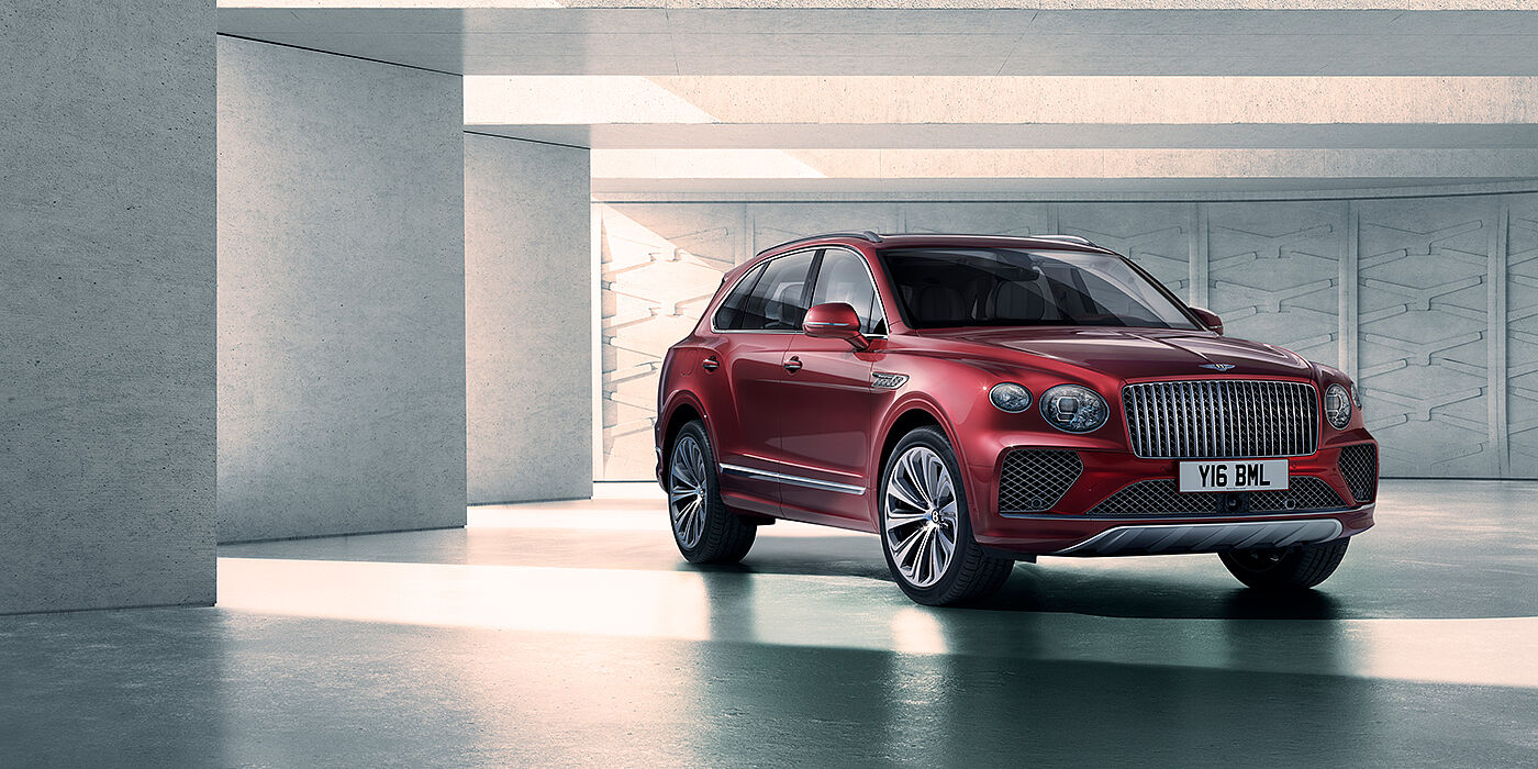 Bentley Hong Kong - DCH Bentley Bentayga Atelier Edition SUV in Rubino Red paint front three quarter against textured concrete wall