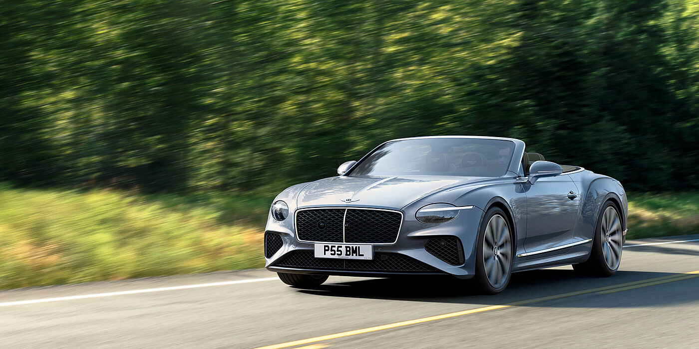 Bentley Hong Kong - DCH New Bentley Continental GTC convertible front view in Silverlake paint with 22 inch ten spoke wheels, driving dynamically on a country road