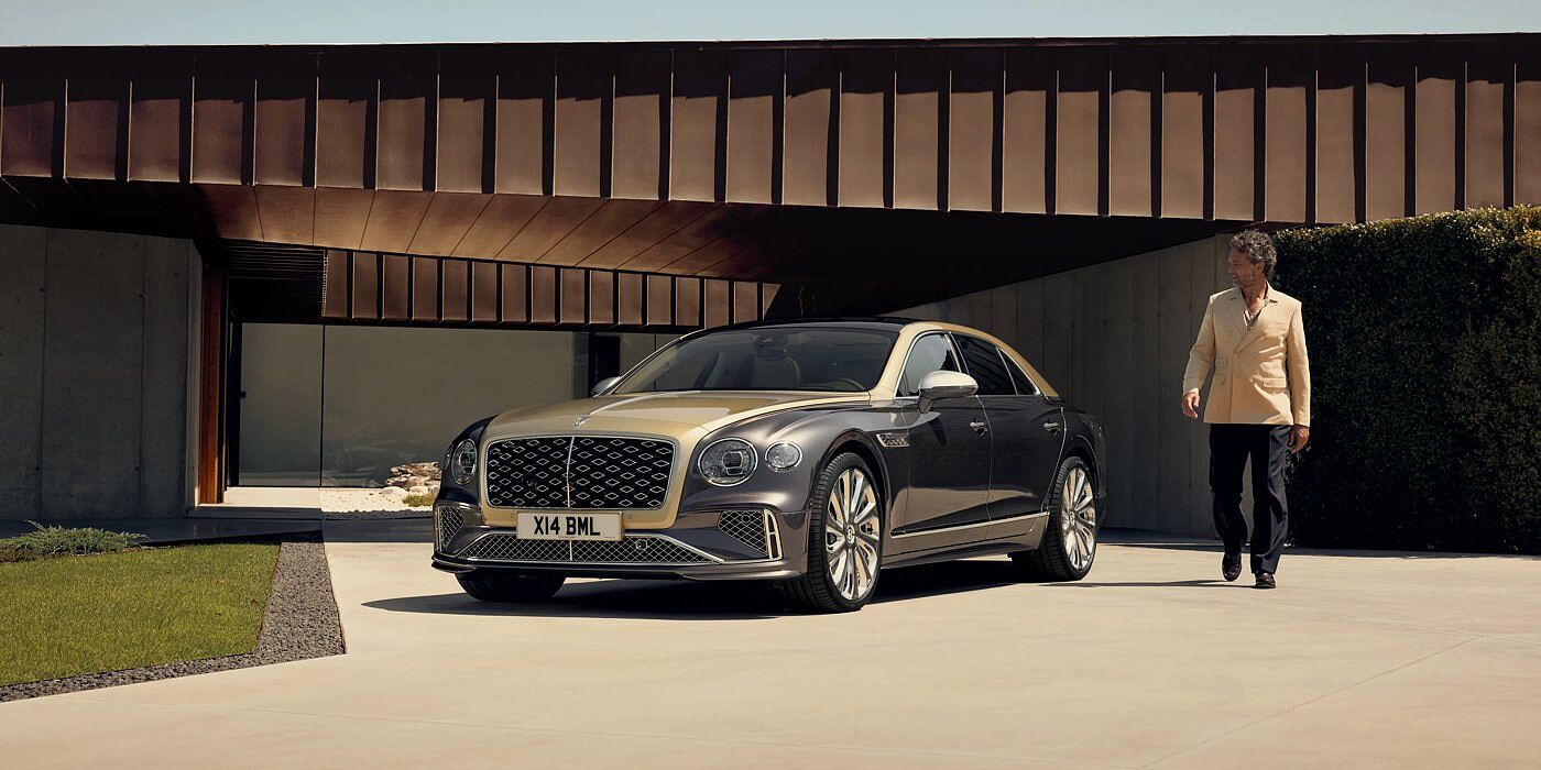 Bentley Hong Kong - DCH Bentley New Flying Spur Mulliner V8 hybrid sedan front three quarters in Rose Gold over Magnetic paint, parked near modern home