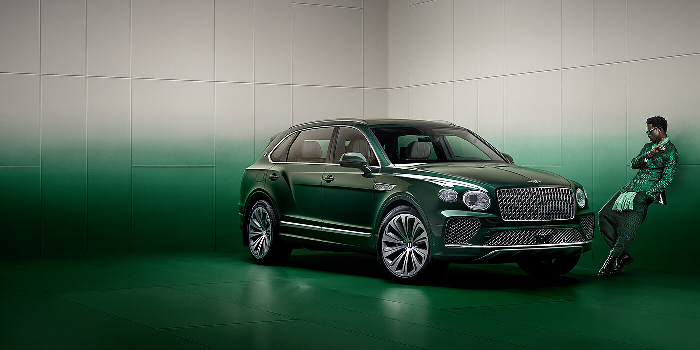 Bentley Hong Kong - DCH Wisdom K leans against wall next to Bentley Bentayga Extended Wheelbase Atelier Edition SUV in Light Emerald green paint