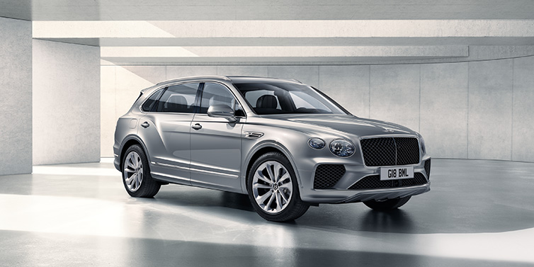 Bentley Hong Kong - DCH Bentley Bentayga Extended Wheelbase SUV front three quarter in Moonbeam paint with a grey background
