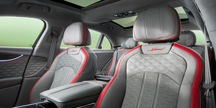 Bentley Hong Kong - DCH Bentley Flying Spur Speed sedan interior showing front and rear seats in Hotspur red and Gravity Grey hides, with Speed seat emblems