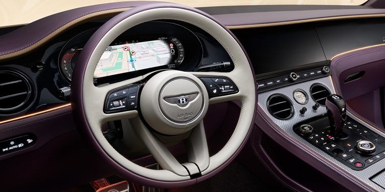 Bentley Hong Kong - DCH Bentley Continental GT Mulliner coupe front interior showing steering wheel and drivers screens surrounded by Linen and Damson hides and Grand Black veneer